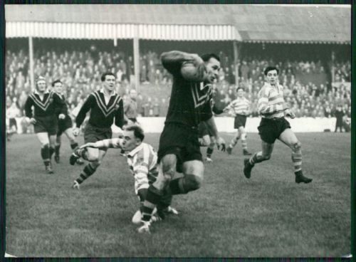 Alex Watson evades the tackle of Frank Stirrup. - Nov 7th 1956.