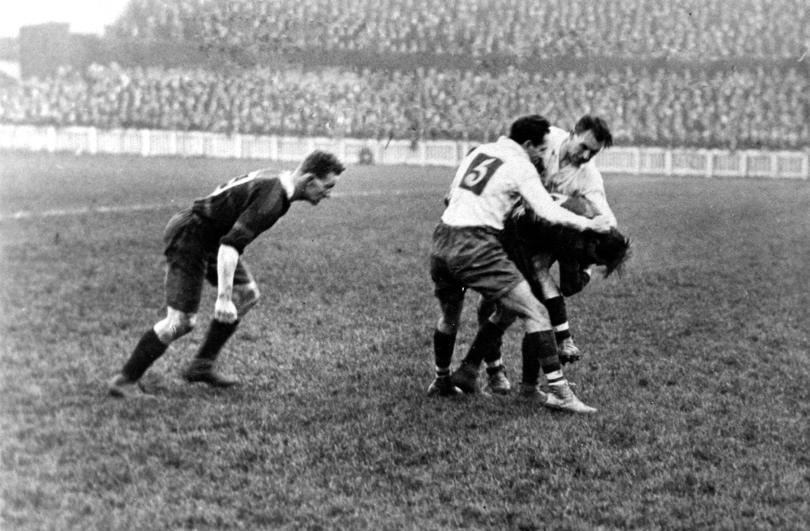 Joe Corsi and Ben Beynon bring down a Barrow player as Burgess looks on - Oct 11th 1924