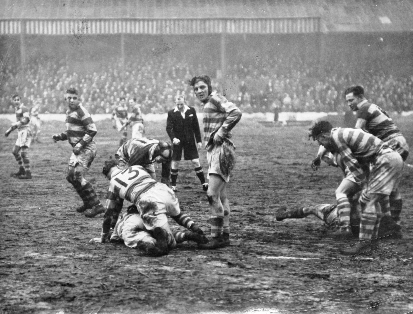Tommy Leyland completes a tackle as Harold Tomlinson and Harry Ogen stand by - Jan 22nd 1949.