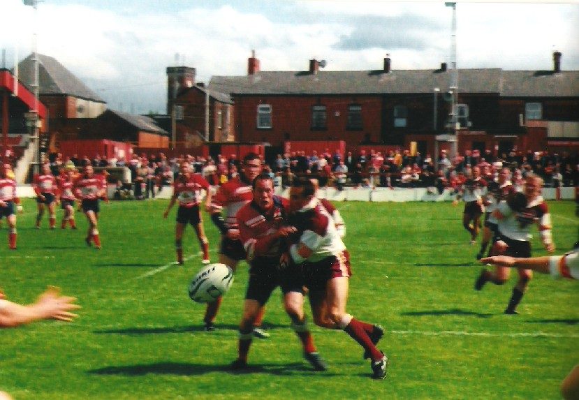 David Gibbons releases a pass in the tackle - June 23rd 2002.