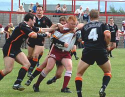 A posse of Oldham defenders bring down Ryan McDonald - June 22nd 2003.