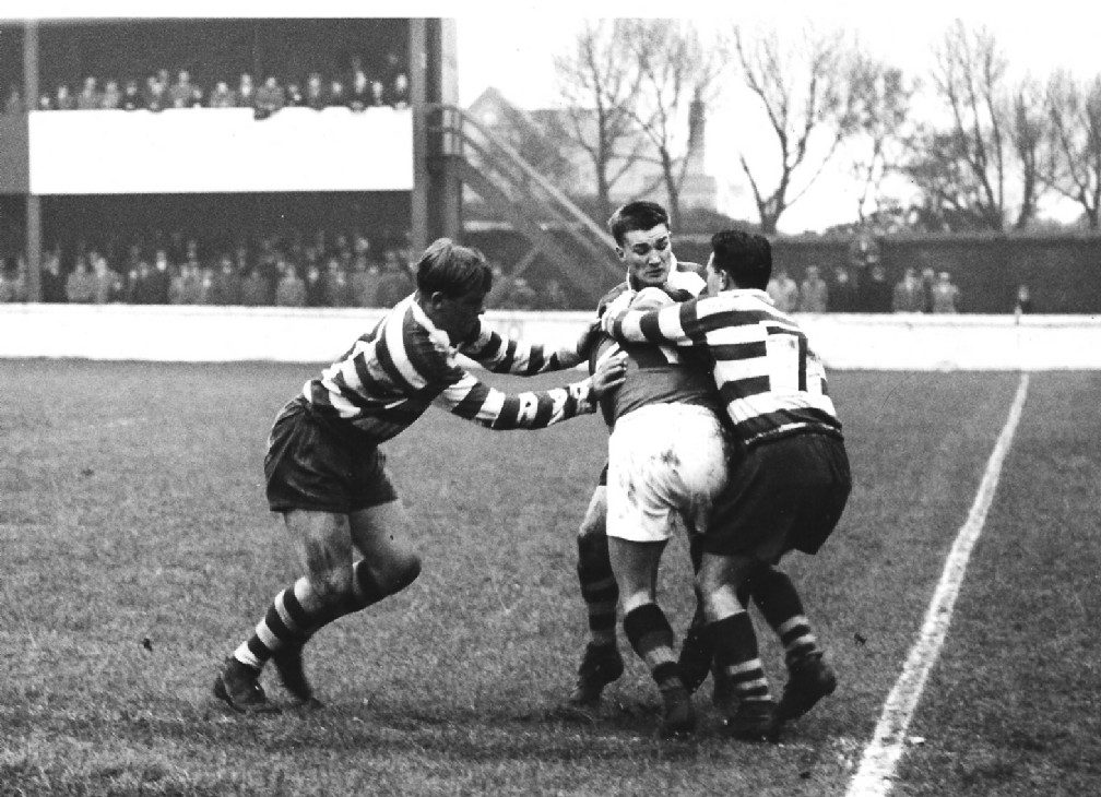 Des McKeown, Geoff Sims and Frank Pitchford tackle a Blackpool player Nov 14th 1959.