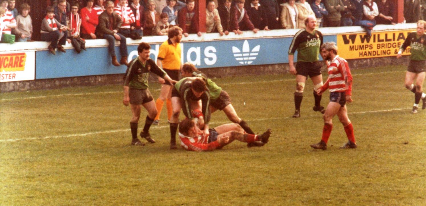 Alan Mc Currie moves in to the play ball from Gareth Owen - March 28th 1982.