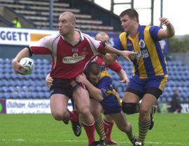Dane Morgan looks to off-load as he powers through a tackle Sep 12th 2004.