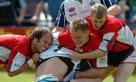 Gareth Barber, Jon Goddard and Andy Gorey wrap up a Featherstone player - July 3rd 2005.