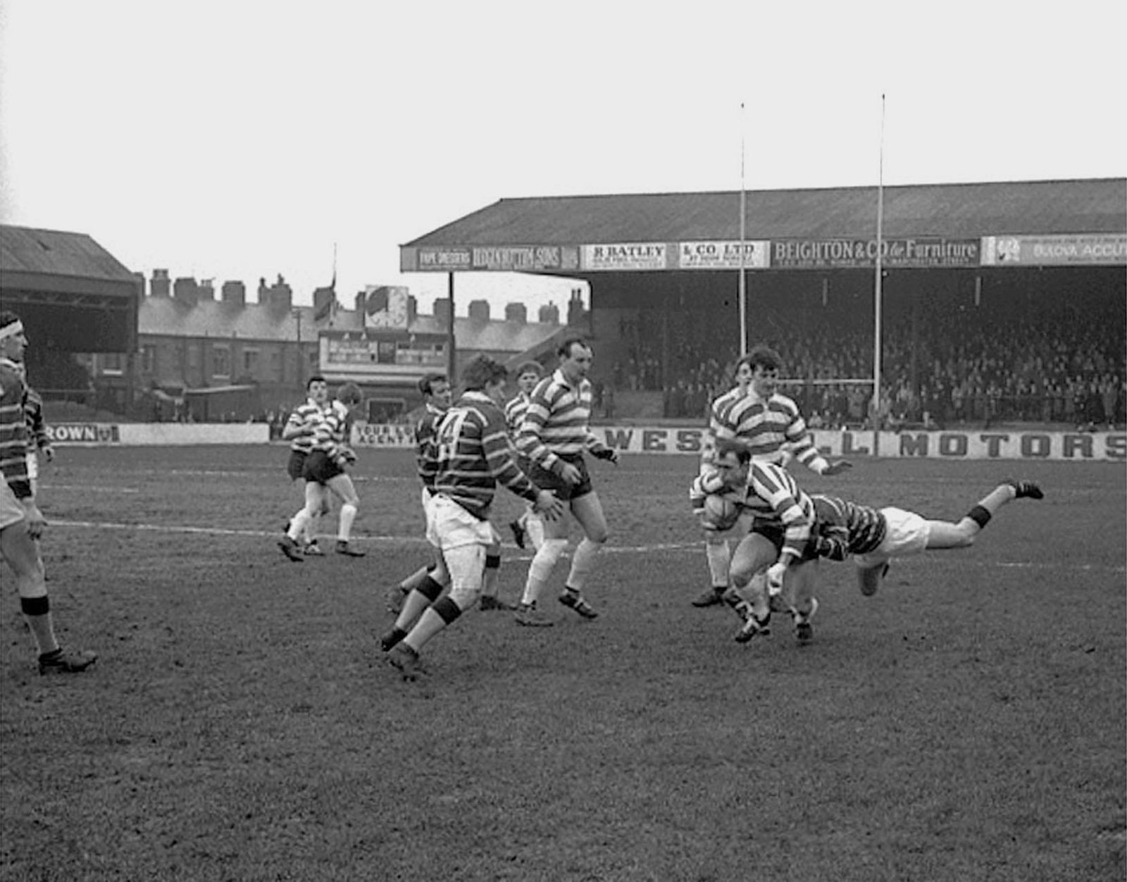Terry Dolly is tackled by a Huddersfield defender with Geoff Fletcher and Trevor Buckley in support - March 11th 1967.