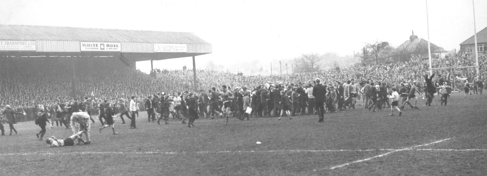 The Oldham fans invade the pitch after Len Mcintyre's equalising drop goal v HKR - April 11th 1964.