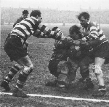 Peter Goddard, Des McKeown and Sid Little bring down Walt Tabern - Feb 14th 1959.