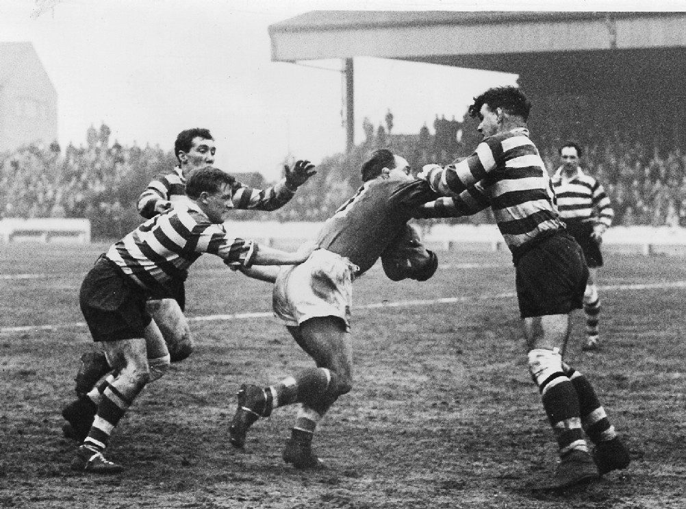 Stan Owen is brought to a halt by Ken Jackson, Des McKeown and Roger Dufty - Feb 14th 1959.