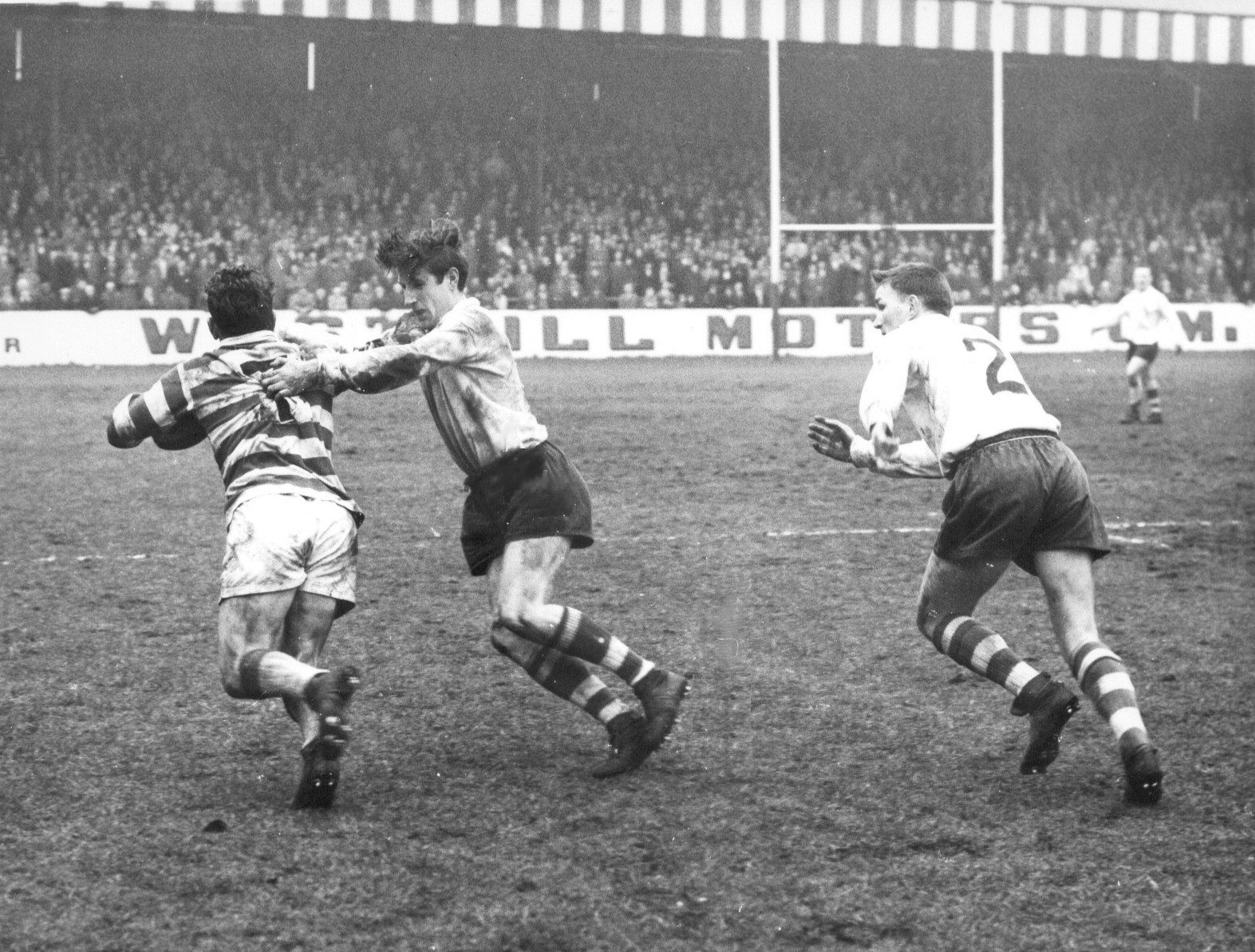 John Donovan tackles Entwistle, the Leigh scrum half with Geoff Sims in support - March 28th 1964.