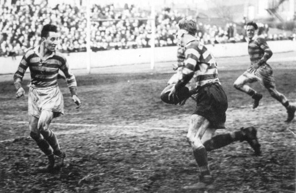 Head bandaged and shirt ripped, Ken Ward takes on Heitzman the Liverpool winger - March 3rd 1951.