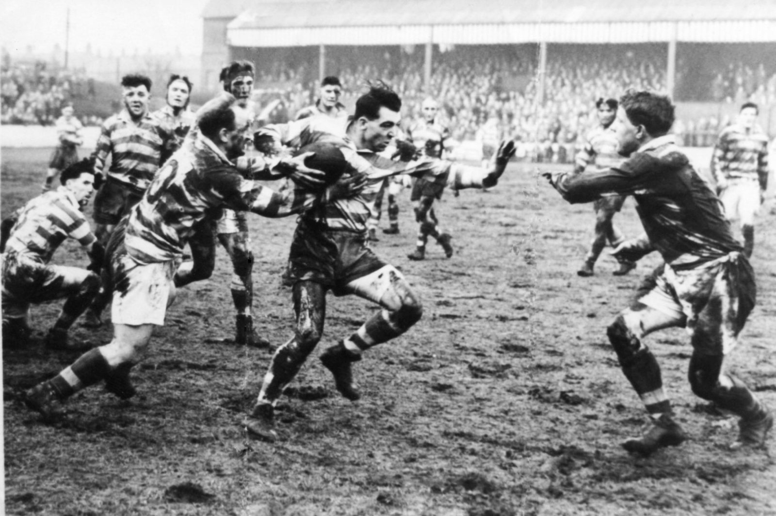 Dick Cracknell evades Welsby and prepares to hand off Collier in the second leg of the cup tie against Liverpool - Feb 13th 1954.