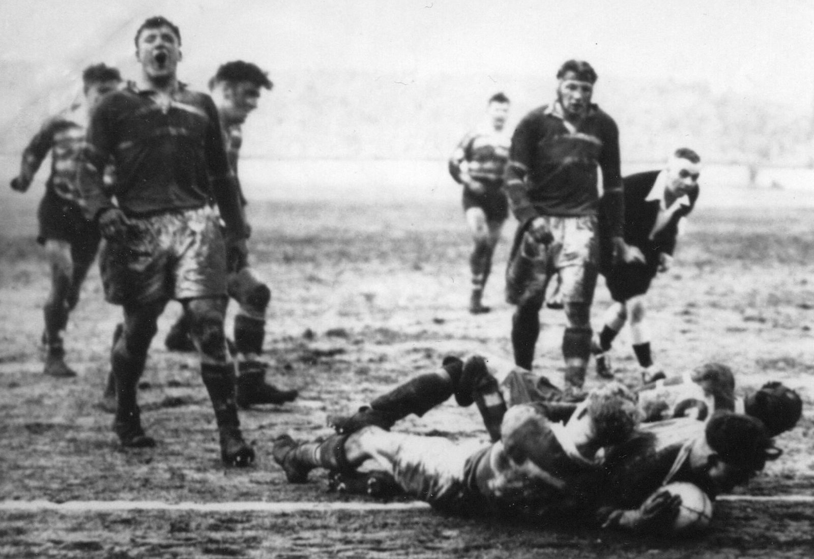Jack Keith plunges over for the winning try with just two minutes left on the clock. Referee, Charlie Appleton has a good look before awarding the score - Jan 29th 1955.