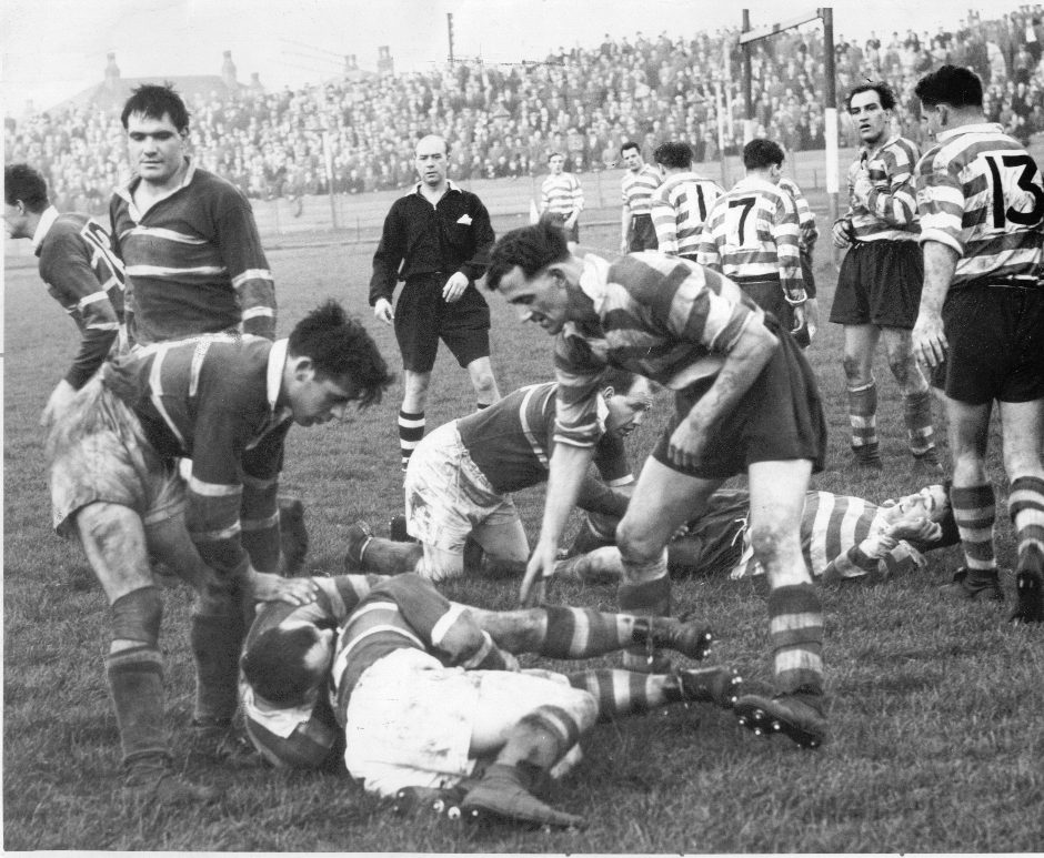 A remarkable photo taken at the Athletic Grounds which shows nine Oldham players. Don Vines struggles for the ball with a Rochdale player as Jack Keith moves in to help - Oct 12 157.