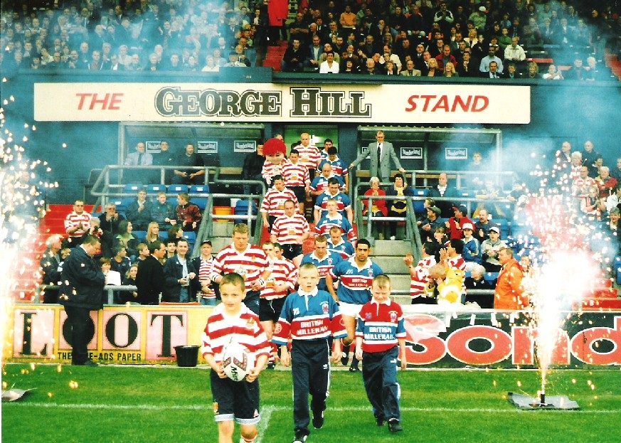 Leo Casey and Willie Swann leads out the teams. Oldham v Rochdale: Oldham Borough 150th anniversary Charter Day celebration - June 13th 1999.