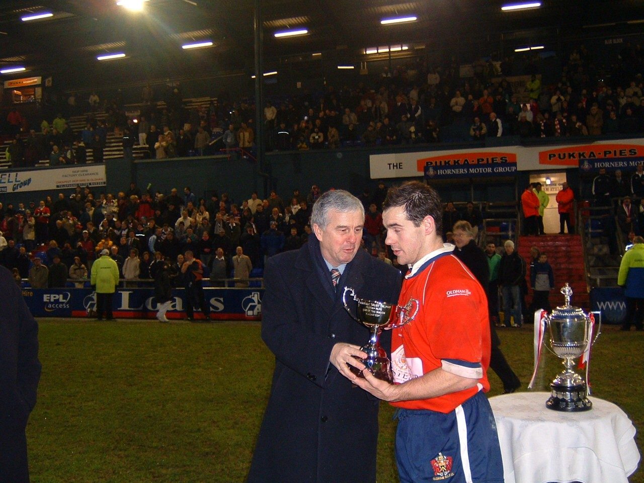 Ian Watson receives the Oldham Rugby League Heritage Trust Trophy from Brian Walker - Jan 18th 2004..