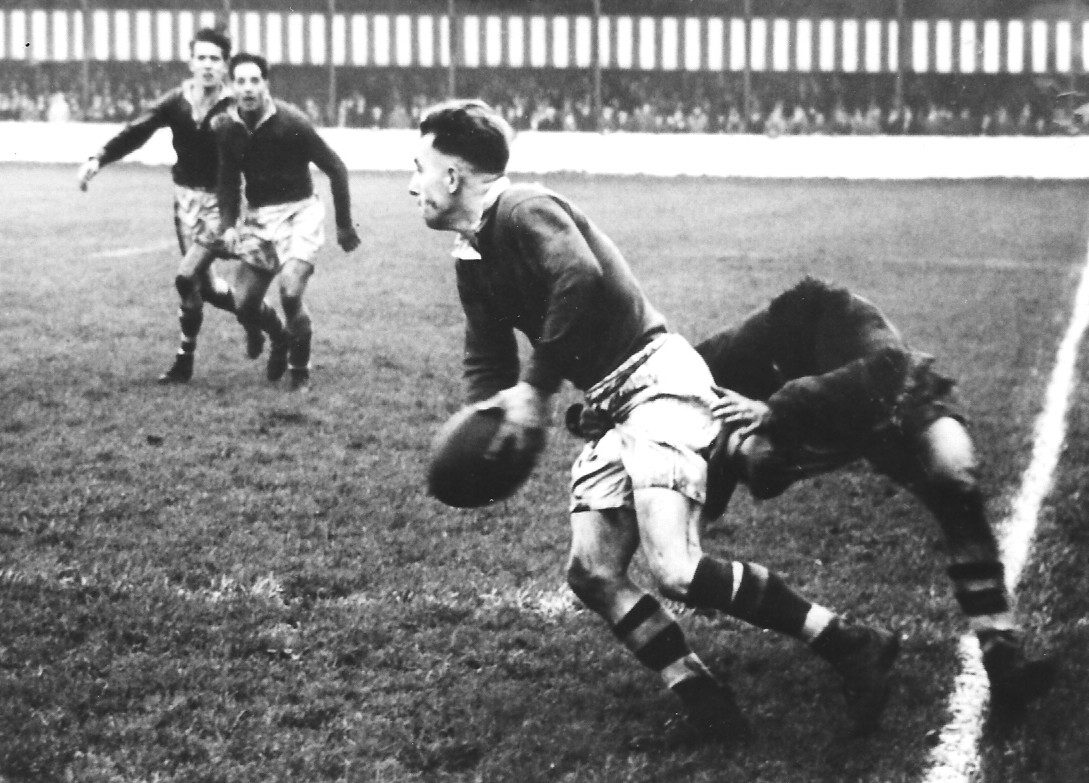 Frank Stirrup playing on the Salford left wing looks to pass before going into touch. Oldham v Salford - Oct 7th 1950.