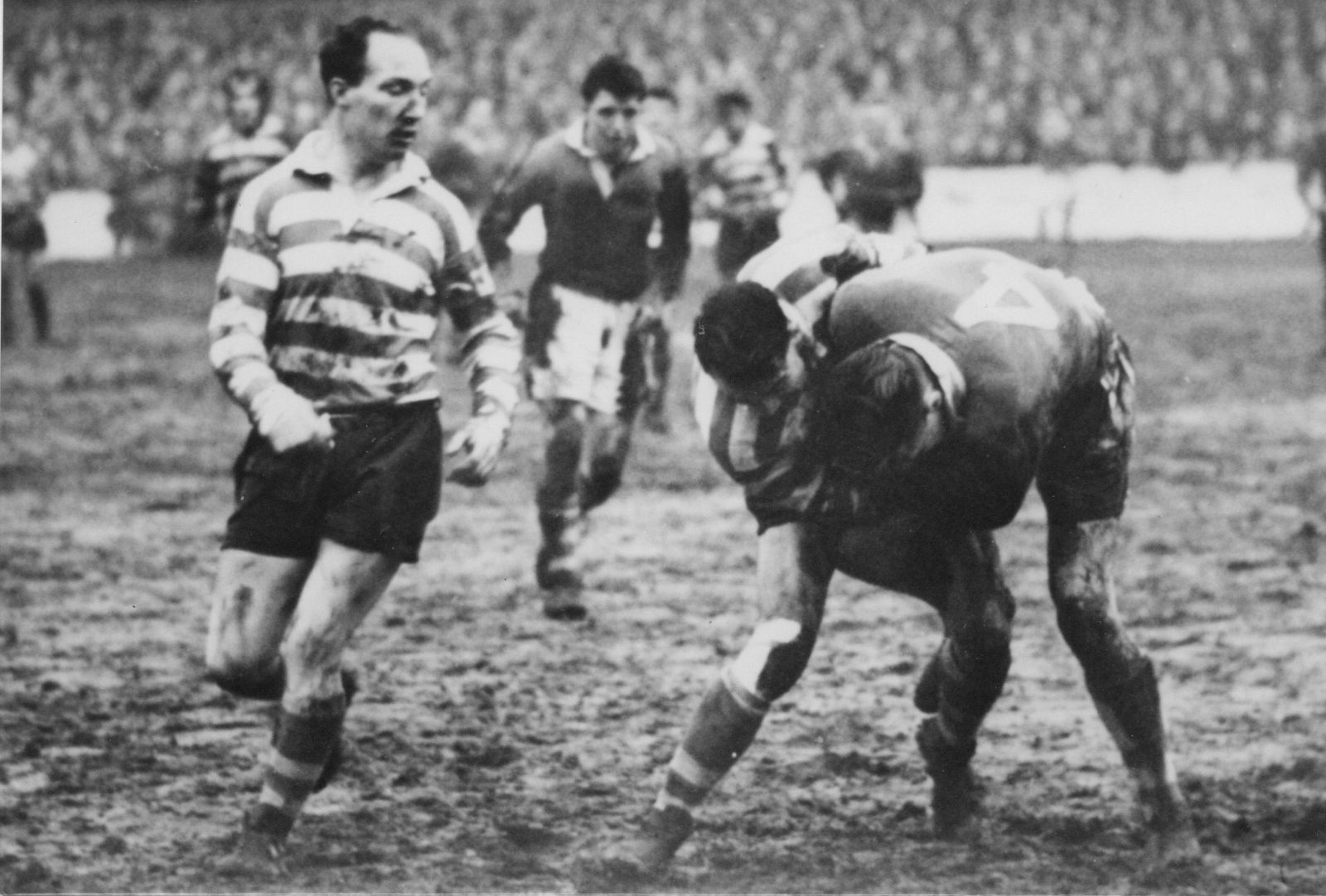 Billy Mitchell looks on as Dick Cracknell contests the ball with the Salford centre Cartwright - Dec 28th 1954.