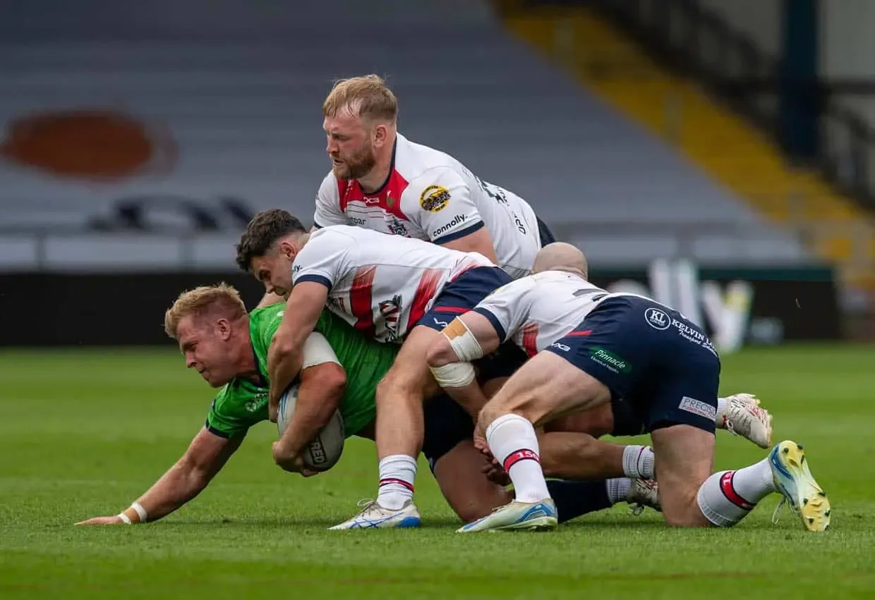 Tom Forber, Matty Wildie and Owen Farnworth tackle an Eagles attacker. Sunday August 9, 2026.