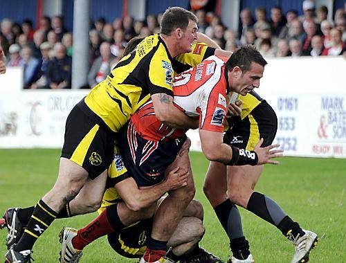 Dave Ellison falls to a three man tackle v South Wales - Aug 1st 2010.