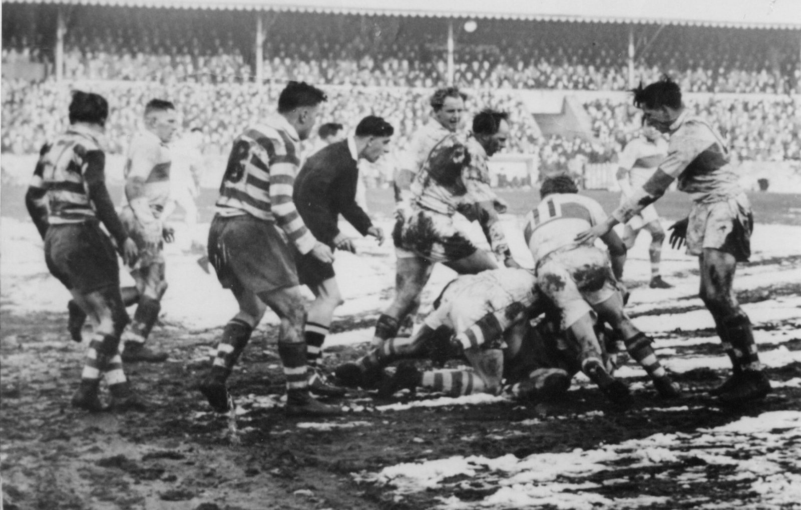 An Oldham player receives some close attention from the St. Helens defence - Feb 19th 1955.