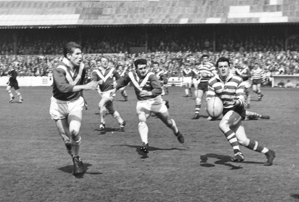 Johnny Noon release a pass as the Swinton cover closes in - April 28th 1962.