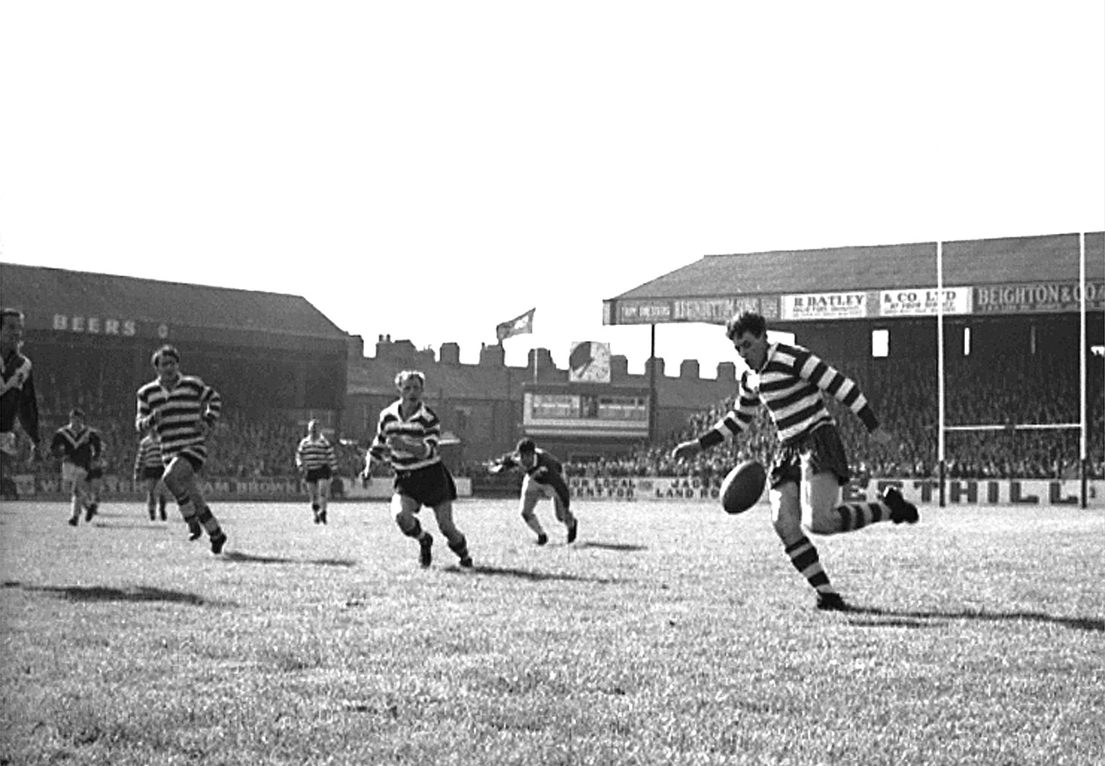 Malcolm Price kicks ahead against Swinton with Jack Pycroft and Ken Wilson in support - Aug 29th 1964.