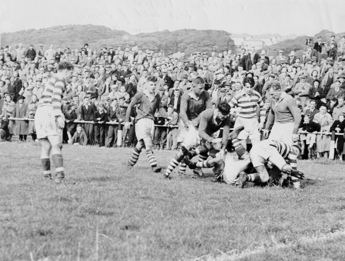 A scramble near the Oldham try-line with several Whitehaven and Oldham players involved as Ken Ward (left) and Joe Warham survey the scene - Aug 19th 1950.