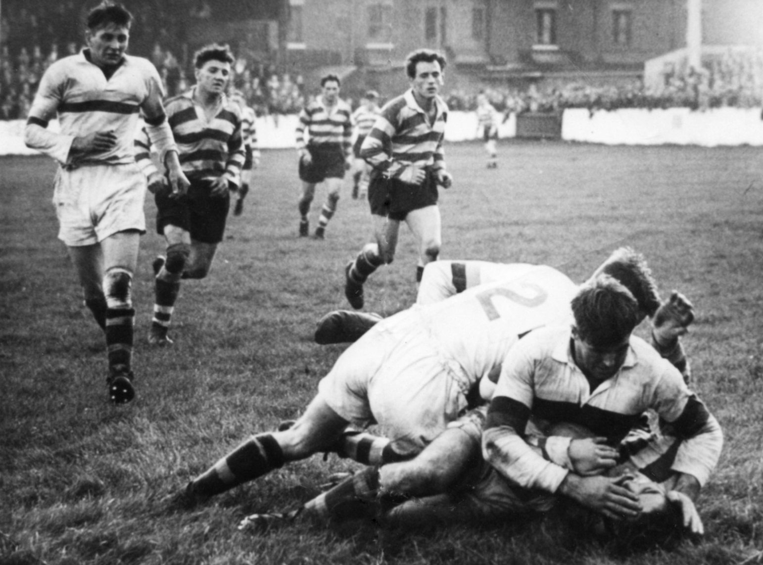 Terry O’Grady gets the ‘treatment’ from Whitehaven's Bill McAlone and ex-Roughyed, Walter Nicholson as Harry Ogden and Jim Mundy move up for the play the ball - Sep 7th 1953.