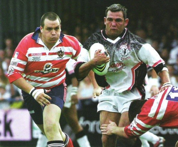 Tommy Hodgkinson takes a tackle from Phil Farrell as danny Guest closes in - July 28th 2001.
