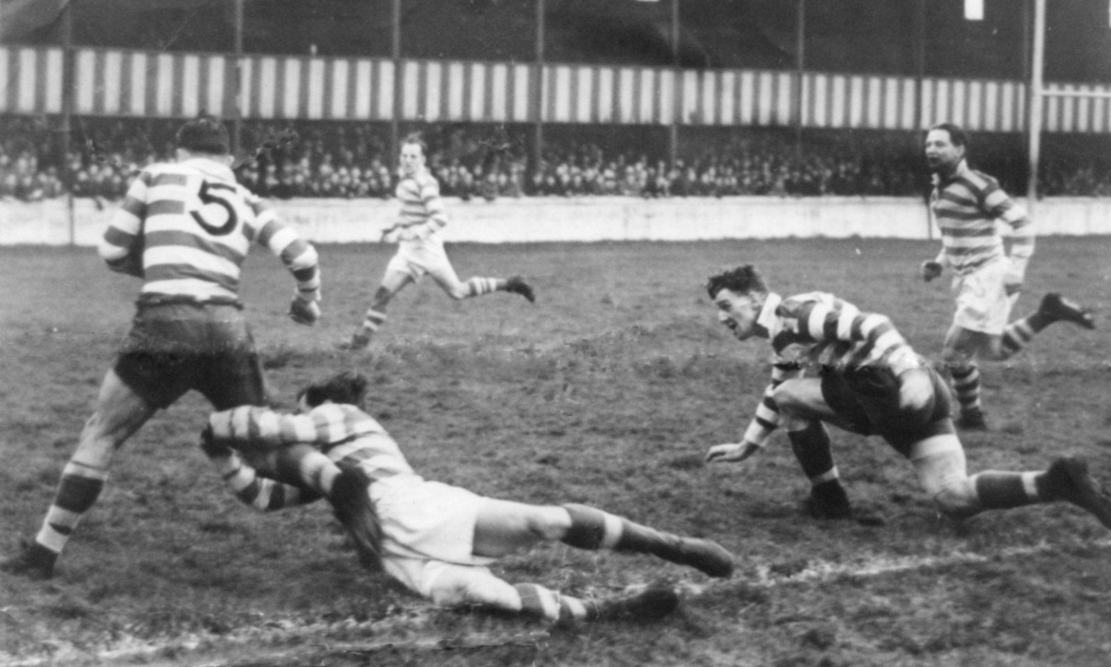 Alan Davies is tackled by Jack Broome watched by Harry Ogden and George Roughley with a young Brian McTigue, making his Wigan debut at centre, covering cross in the background April 23rd 1951.