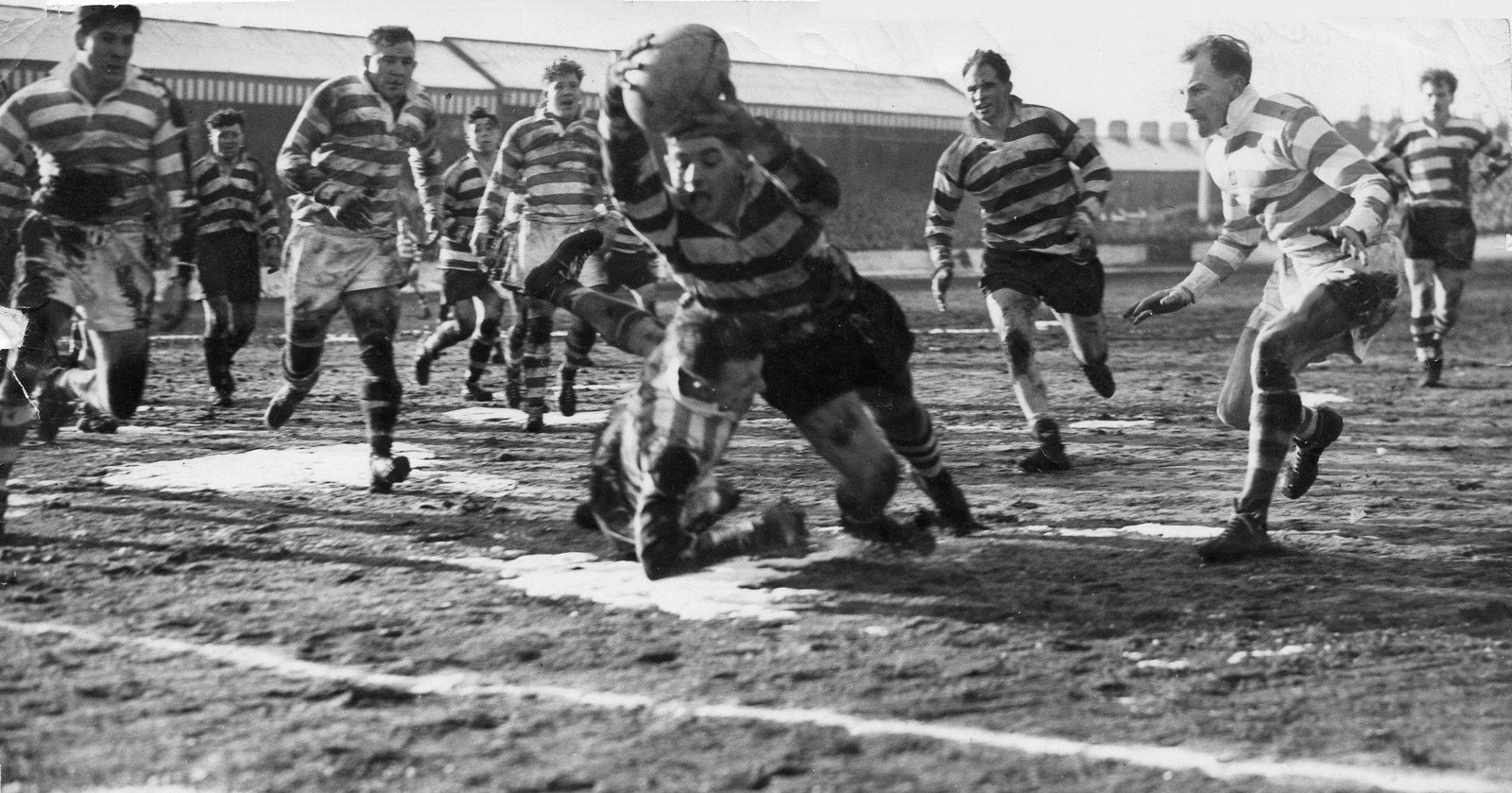 Alan Davies dives over in Don Platt’s tackle on a cold Watersheddings pitch - Feb 12th 1955.