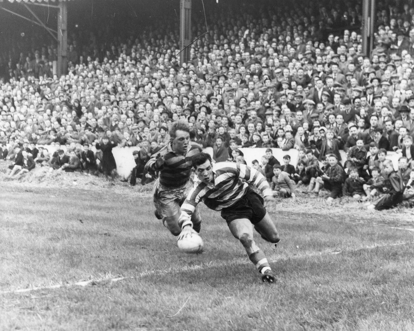 Alan Davies avoids Norman Cherrington to score at Watersheddings - March 30th 1957.