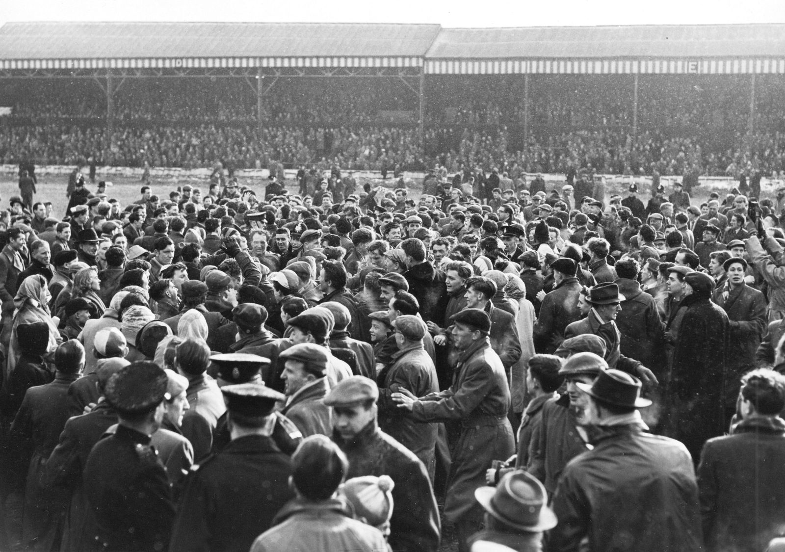 The crowd spill on to the pitch to congratulate the victorious Wigan team - March 8th 1958.