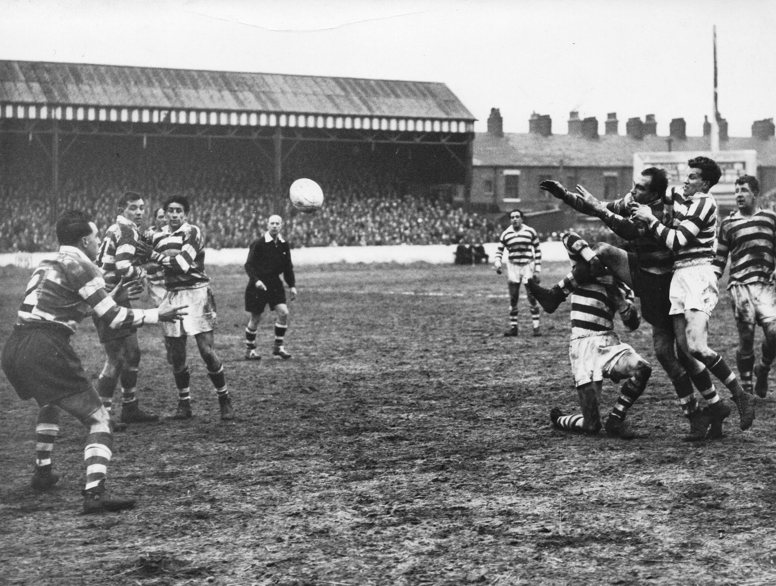 Charlie Winslade passes toDick Cracknell in Mick Sullivan's tackle - April 5th 1958.