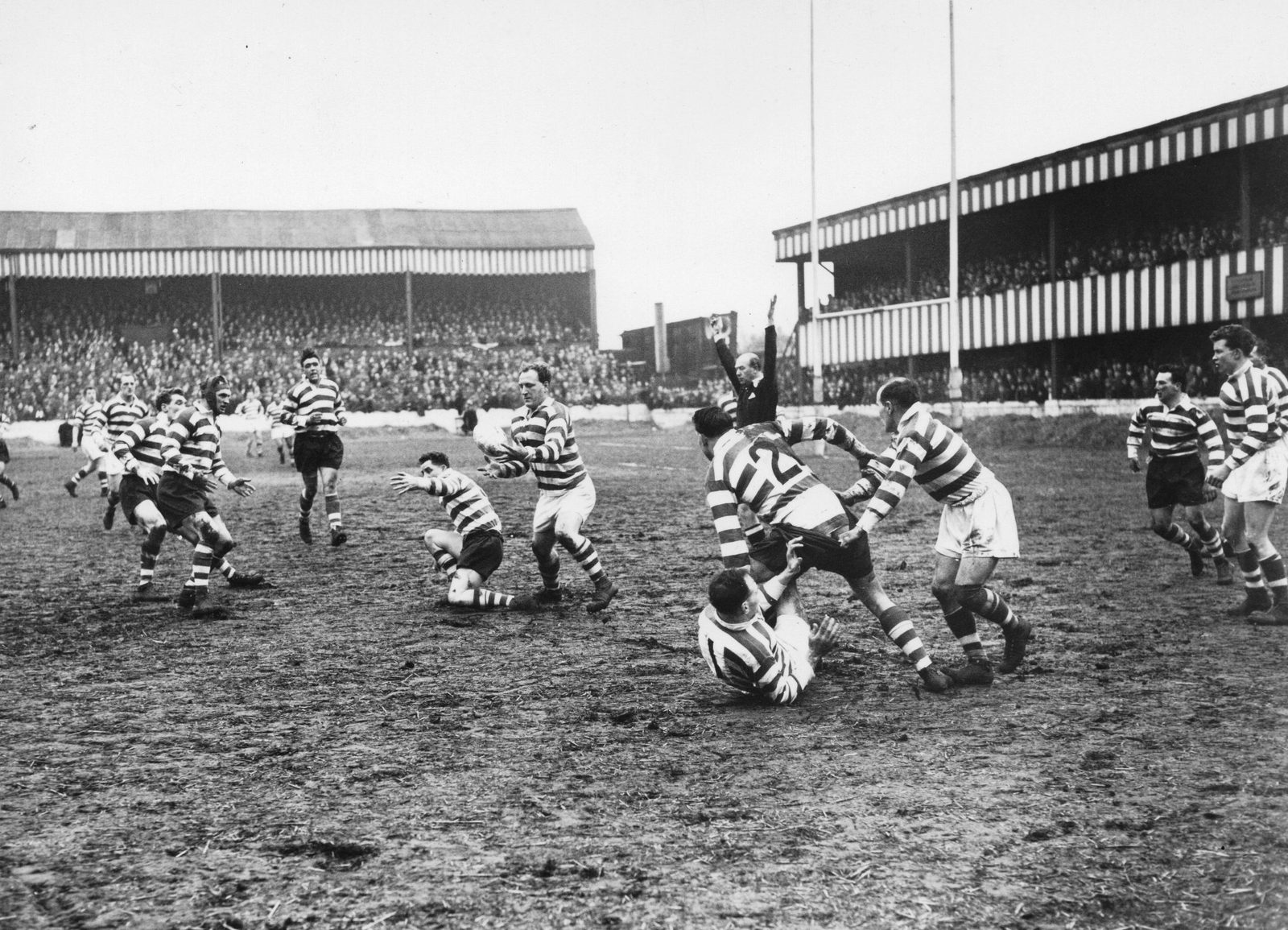 Brian McTigue snaps up a loose ball - April 5th 1958.