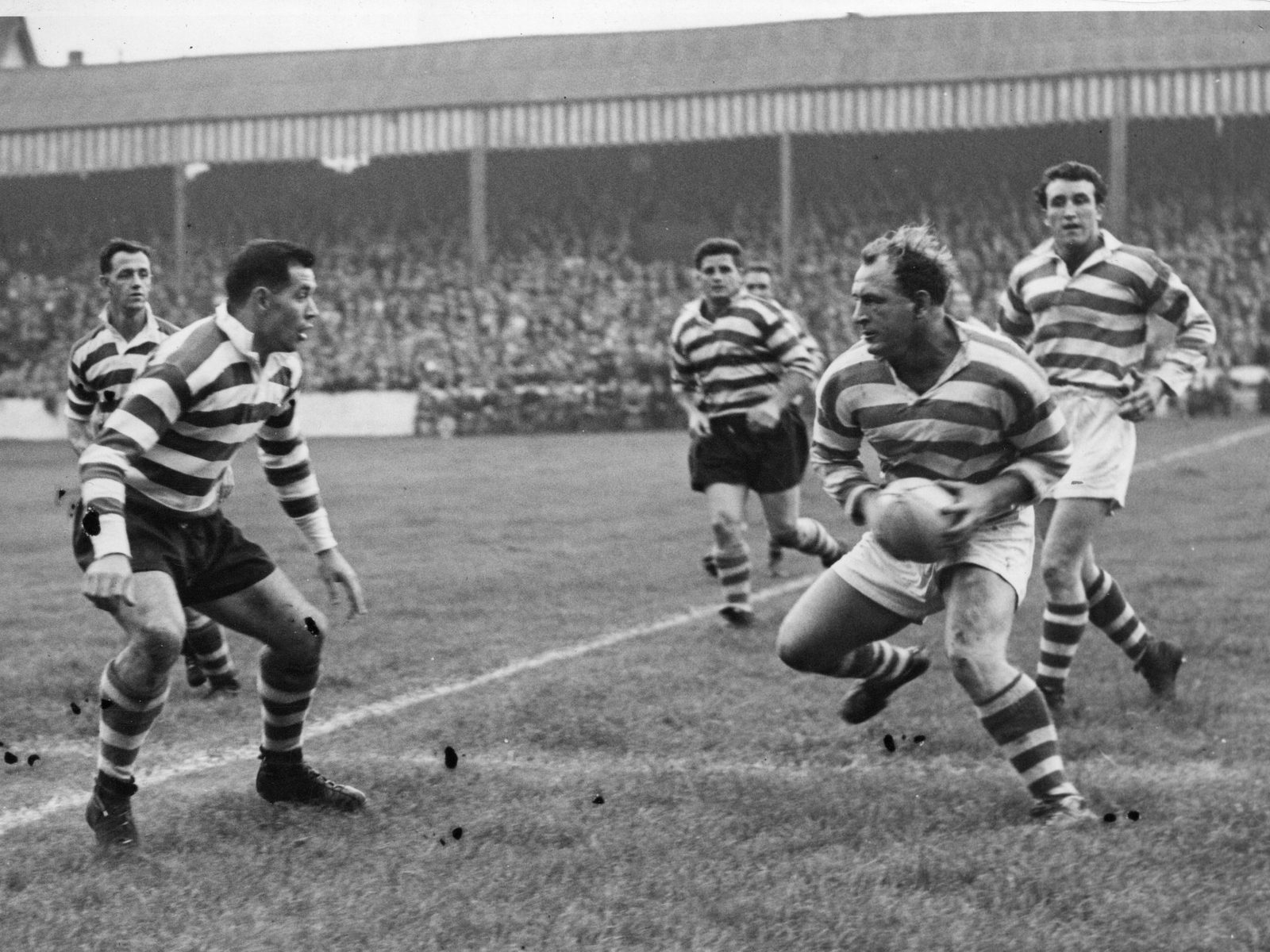 Alan Davies prepares to tackle Brian McTigue of Wigan Sep 16th 1958.