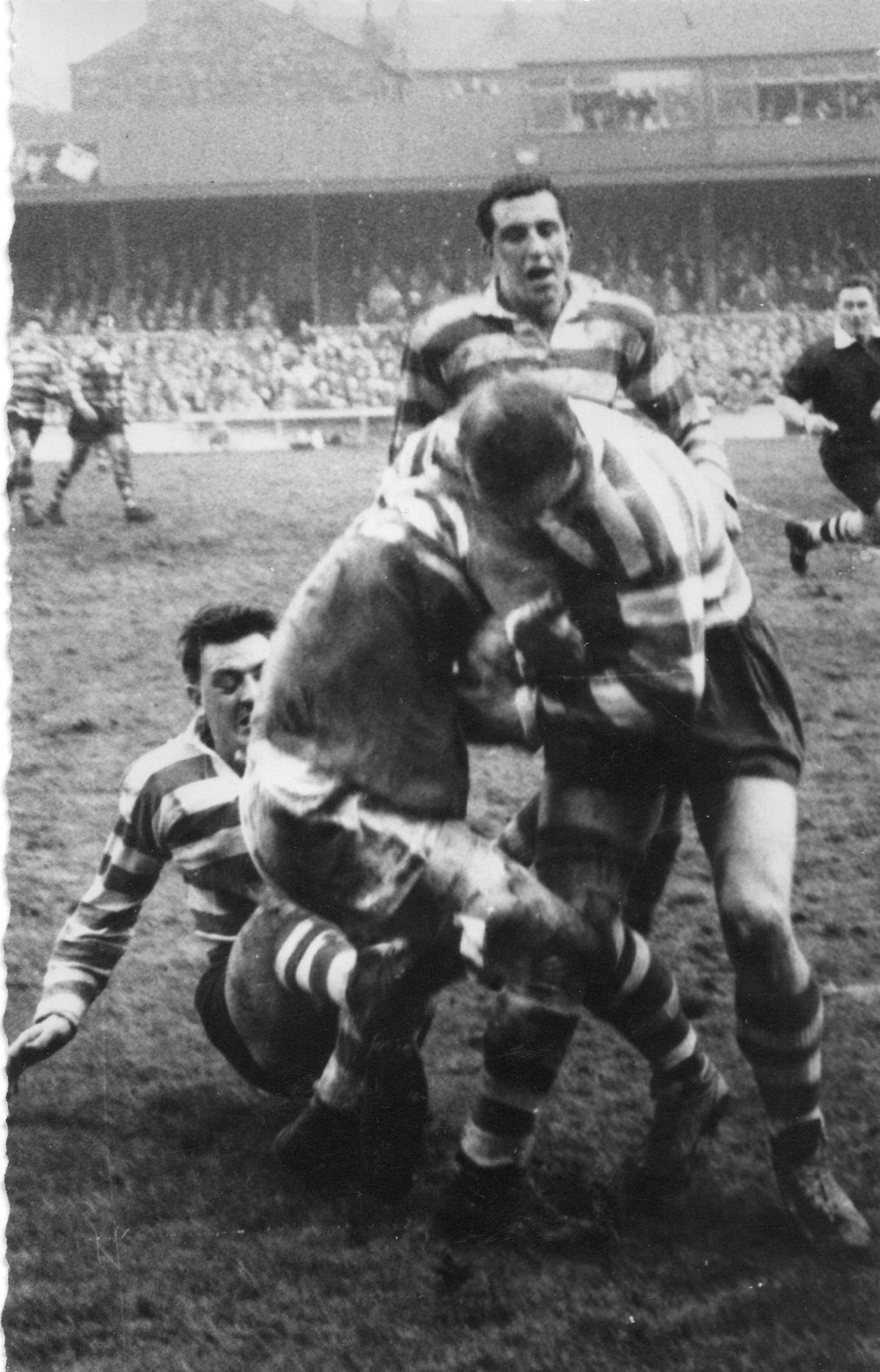 Wigan v Oldham. John Noon and John Rae wach a team-mate make a tackle - Jan 13th 1962.