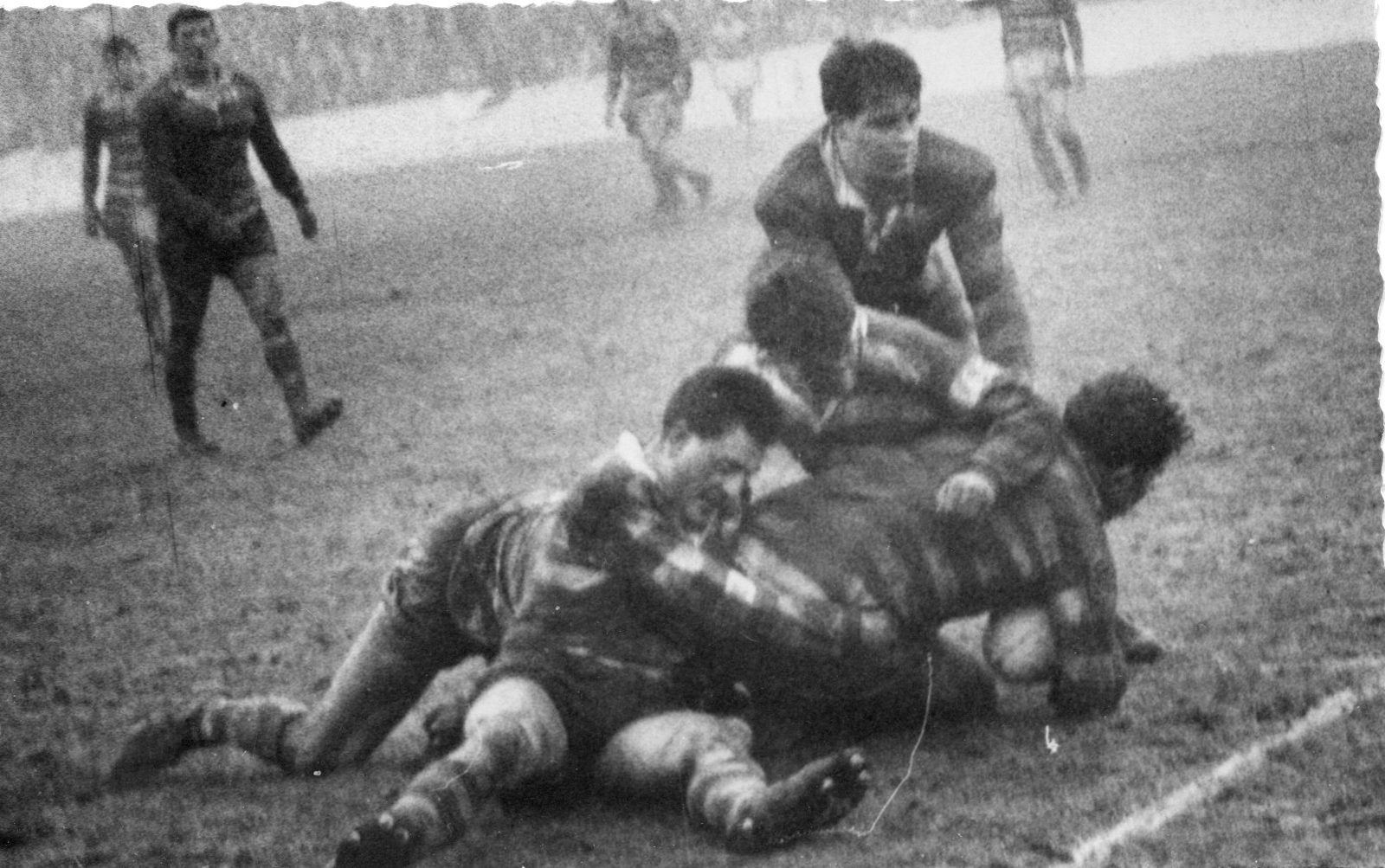 Frank Collier is tackled by thee Oldham defenders - Jan 20th 1962.