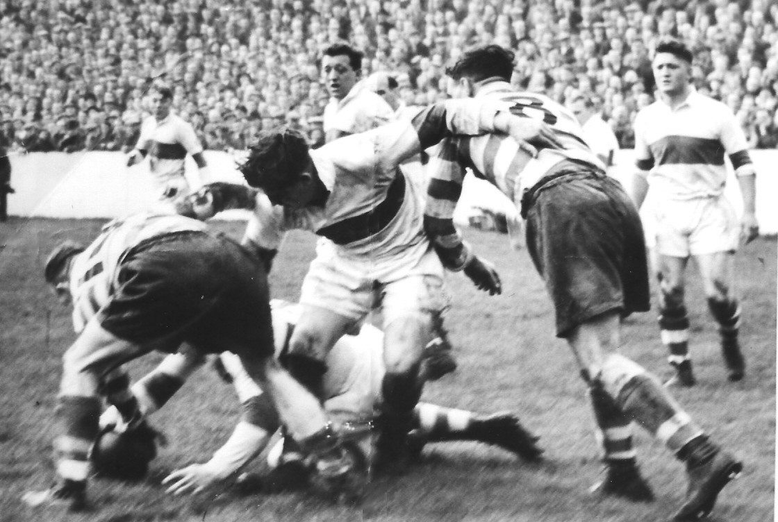 Arthur Tomlinson battles for a loose ball against Workington as Ken Jackson lends his weight to the situation - Oct 9th 1954.