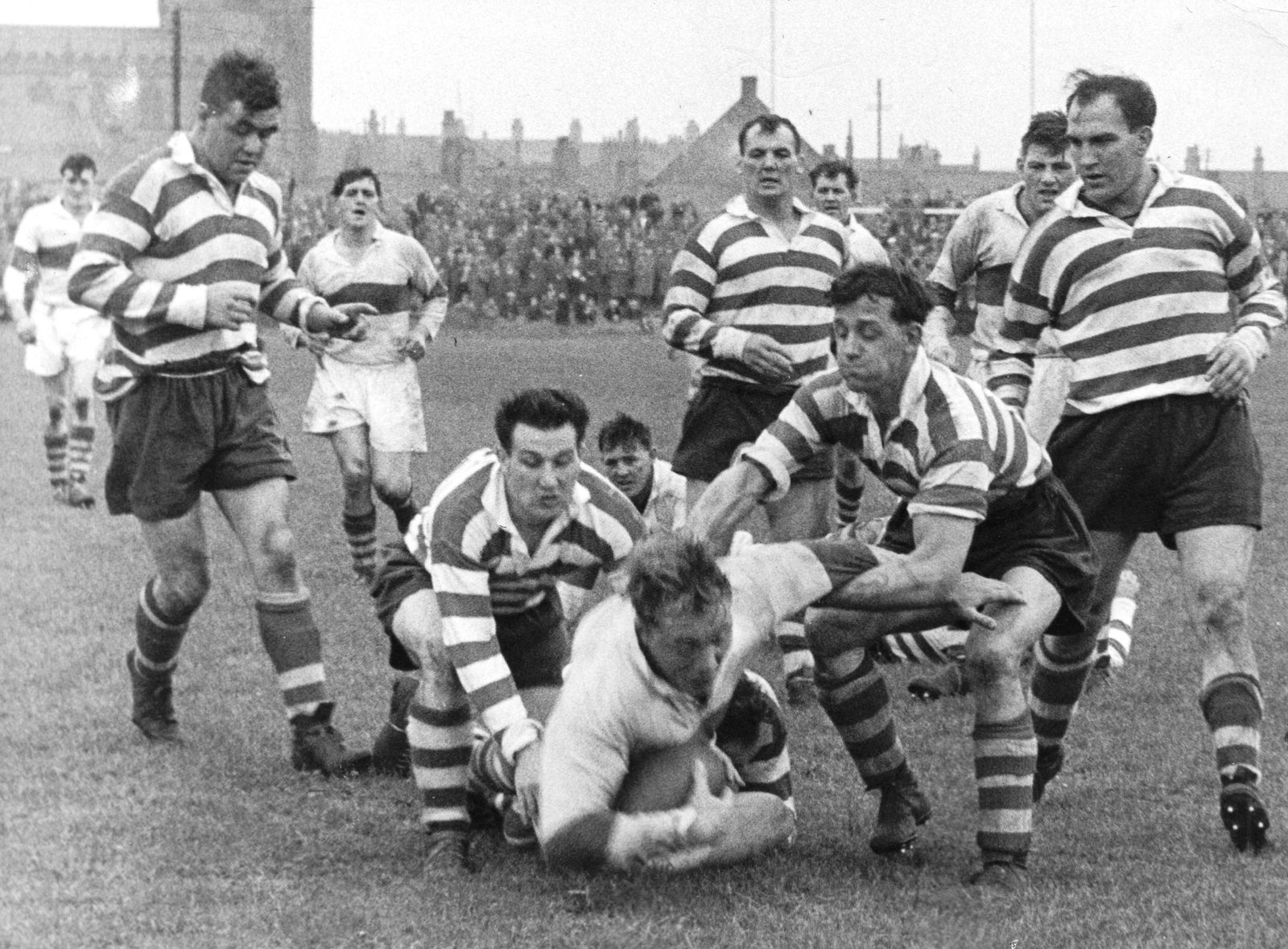 Frank Pitchford and Jack Keith tackle the Workington forward Norman Herbert - Sep 28th 1957.