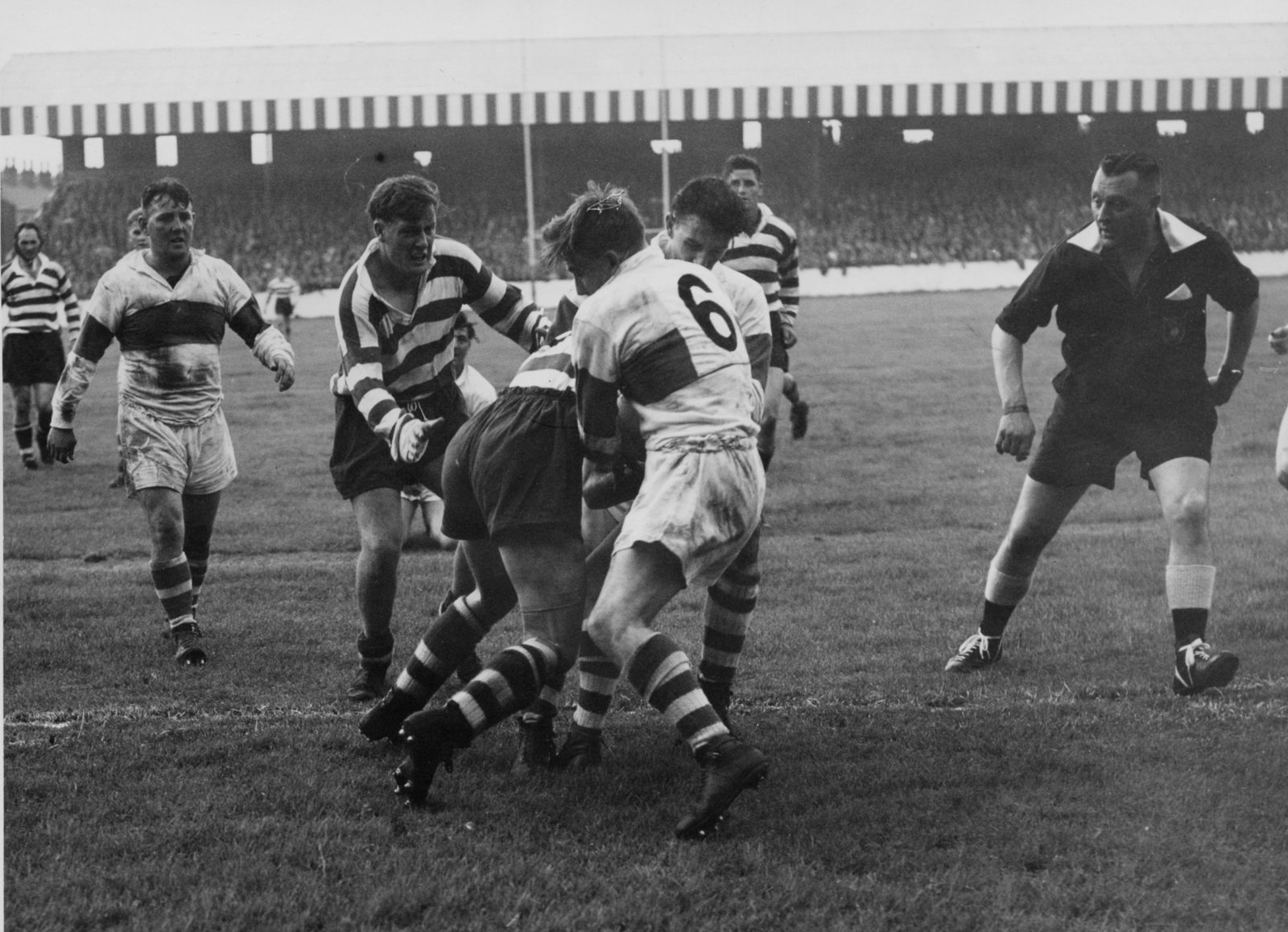 Referee, Eric Clay keeps an eye on the action as Sol Roper makes a tackle with Des McKeown standing by - Sep 2nd 1958.