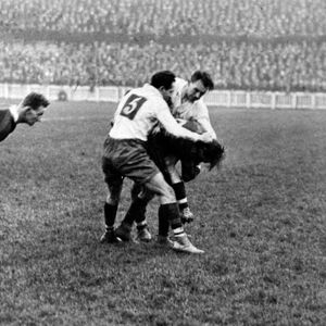 Joe Corsi and Ben Beynon bring down a Barrow player as Burgess looks on - Oct 11th 1924
