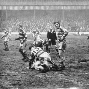 Tommy Leyland completes a tackle as Harold Tomlinson and Harry Ogen stand by - Jan 22nd 1949.