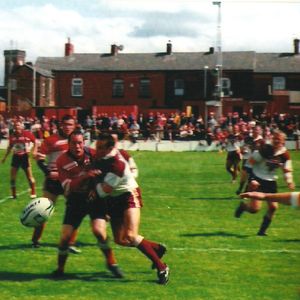 David Gibbons releases a pass in the tackle - June 23rd 2002.