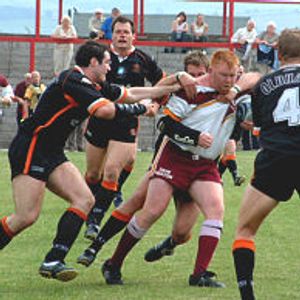 A posse of Oldham defenders bring down Ryan McDonald - June 22nd 2003.