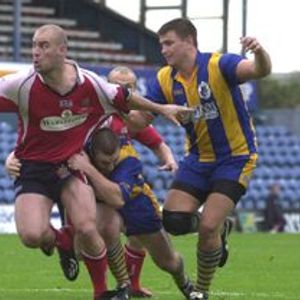Dane Morgan looks to off-load as he powers through a tackle Sep 12th 2004.