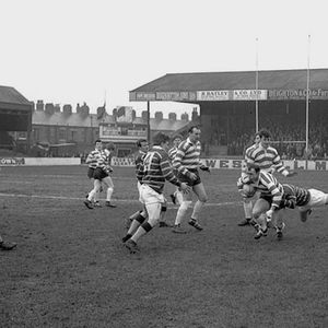 Terry Dolly is tackled by a Huddersfield defender with Geoff Fletcher and Trevor Buckley in support - March 11th 1967.