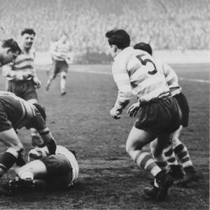 Alan Davies falls to a two-man Leeds tackle with Harry Ogden, Terry O’Grady and Frank Pitchford mostly hidden in …