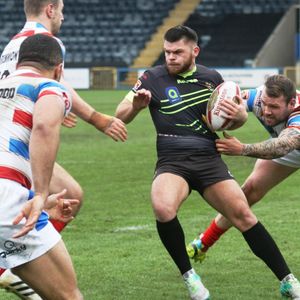 Josh Crowley grabs the shirt of David Hewitt. Rochdale v Oldham - March 12th 2017.